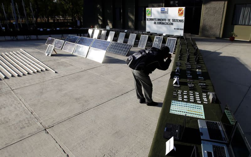 FILE PHOTO: A reporter takes a picture of radio communication systems displayed to the media at the 7th Military zone, on the outskirts of Monterrey