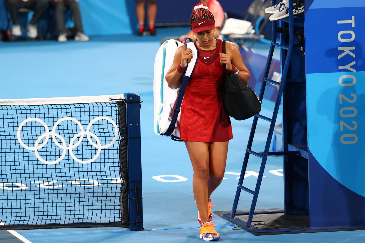 Naomi Osaka walks away after defeat (Reuters)