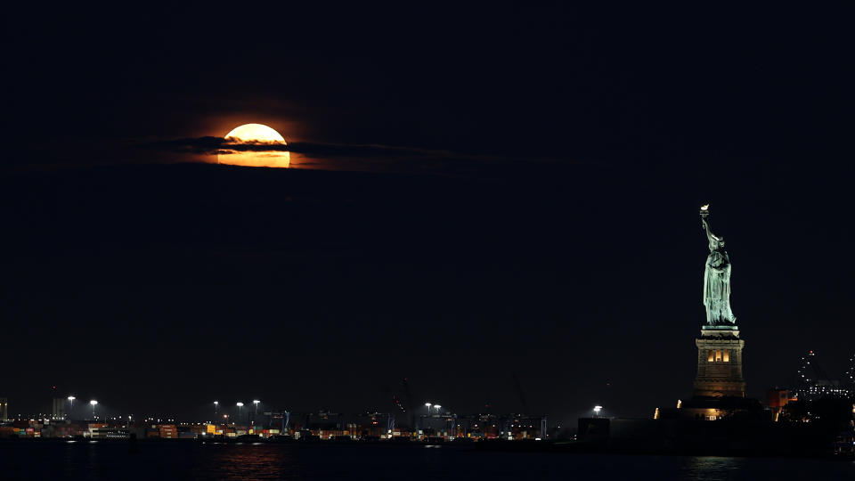 The Buck Moon supermoon as seen over New York and Lady Liberty on July 3, 2023.