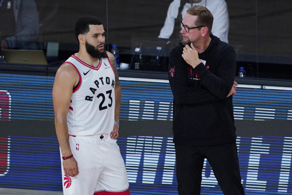 Toronto Raptors' head coach Nick Nurse, right, speaks with Fred VanVleet during the second half of an NBA basketball game against the Los Angeles Lakers, Saturday, Aug. 1, 2020, in Lake Buena Vista, Fla. (AP Photo/Ashley Landis, Pool)