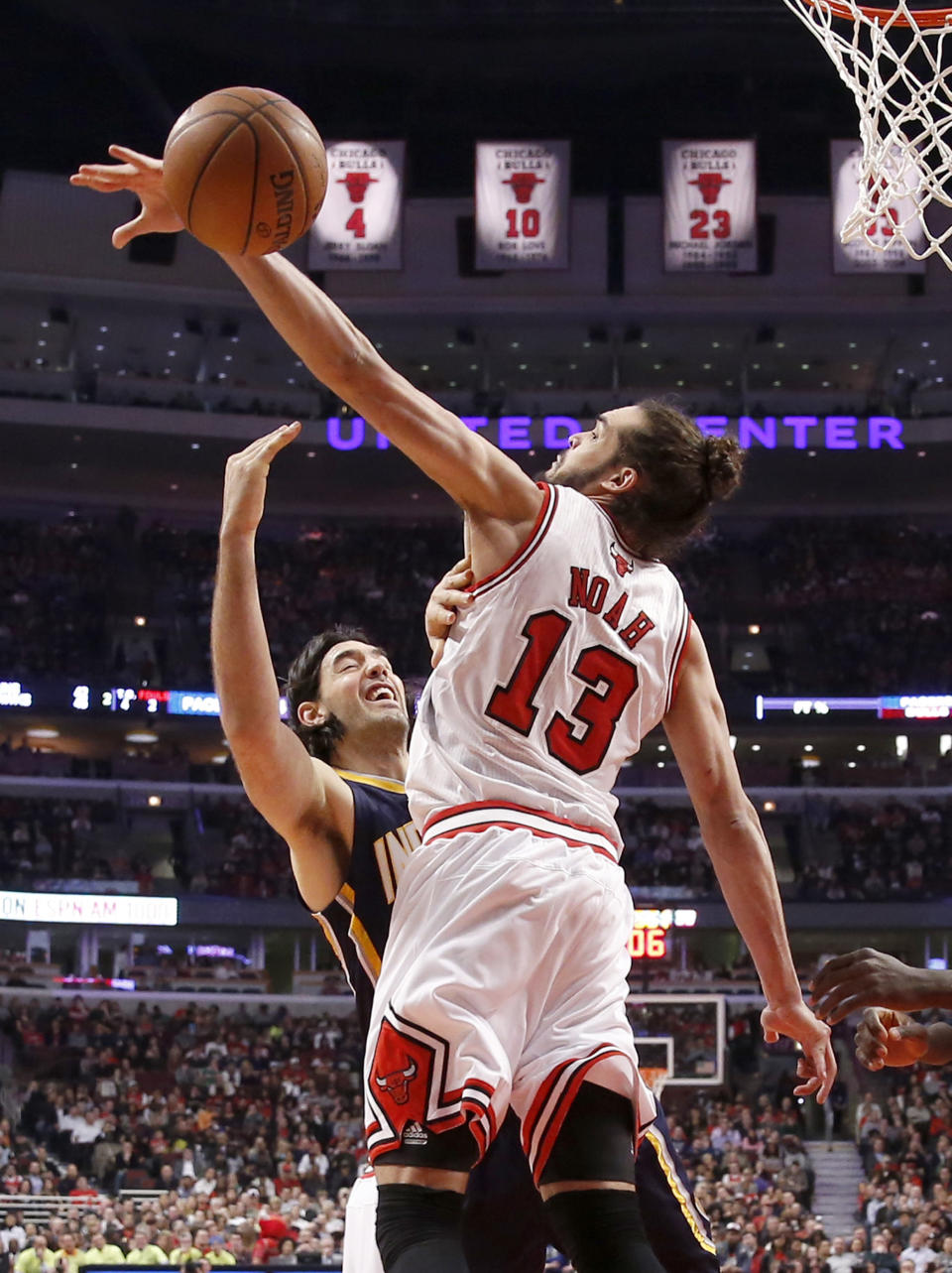 FILE - In this March 24, 2014 file photo, Chicago Bulls center Joakim Noah (13) blocks the shot of Indiana Pacers forward Luis Scola during the first half of an NBA basketball game in Chicago. A person familiar with the situation says Bulls center Joakim Noah is the NBA's Defensive Player of the Year. The person spoke Monday, April 21, 2014, on the condition of anonymity because the award had not been announced. (AP Photo/Charles Rex Arbogast, File)