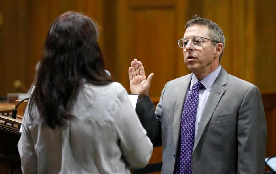 Incumbent councilmen Richard Ollis takes his oath of office in the council chambers on Thursday, April 18, 2019.