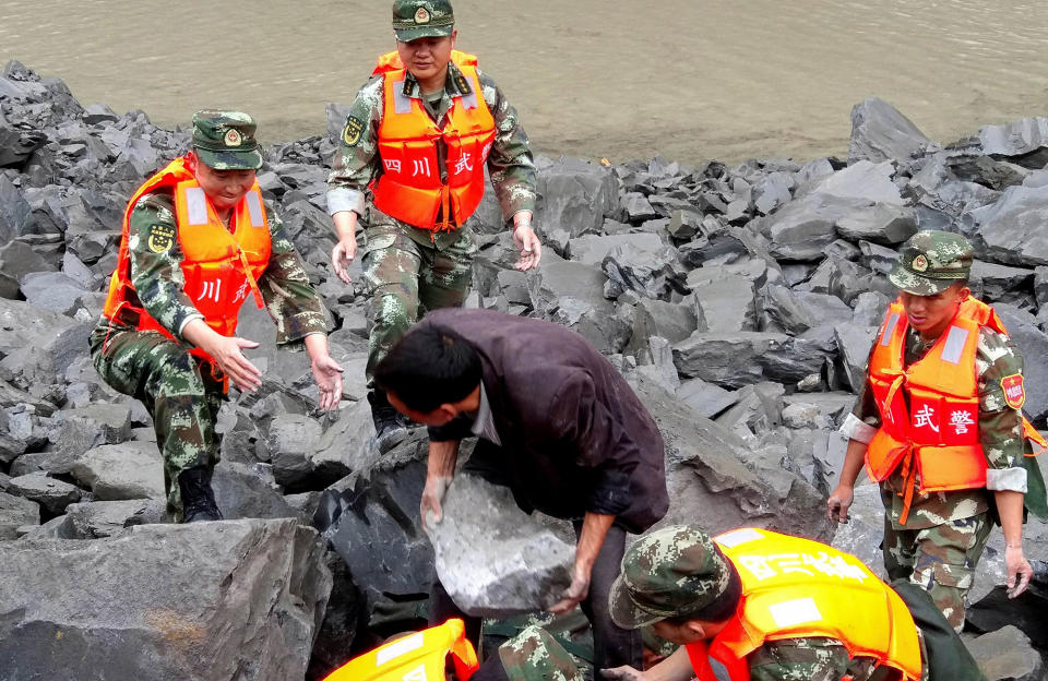 Rescue personnel lift boulders