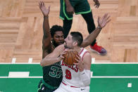 Chicago Bulls center Nikola Vucevic, right, drives to the basket against Boston Celtics forward Semi Ojeleye, left, during the first half of an NBA basketball game, Monday, April 19, 2021, in Boston. (AP Photo/Charles Krupa)