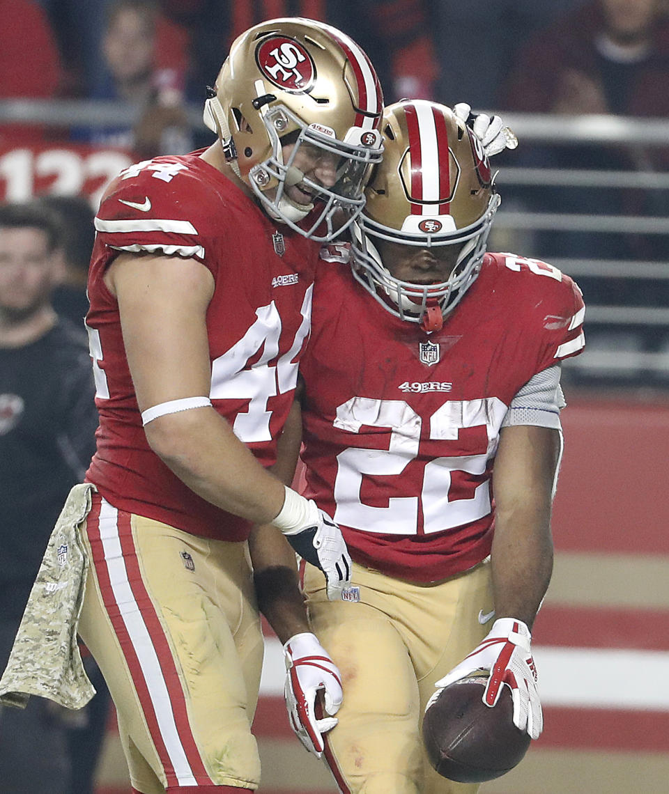 San Francisco 49ers running back Matt Breida (22) celebrates with fullback Kyle Juszczyk (44) after scoring a touchdown against the New York Giants during the second half of an NFL football game in Santa Clara, Calif., Monday, Nov. 12, 2018. (AP Photo/Tony Avelar)