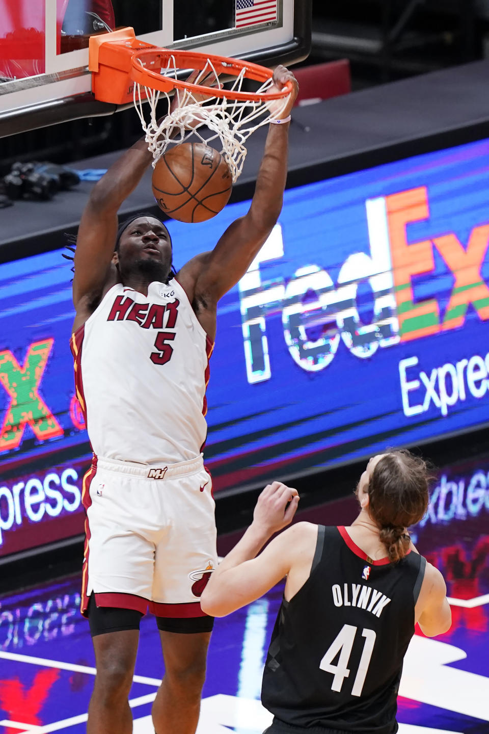 Miami Heat forward Precious Achiuwa (5) dunks the ball over Houston Rockets forward Kelly Olynyk (41), during the first half of an NBA basketball game, Monday, April 19, 2021, in Miami. (AP Photo/Marta Lavandier)