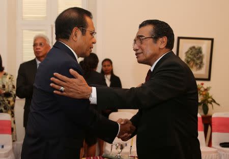 Former East Timor independence fighter Jose Maria de Vasconcelos, popularly known as Taur Matan Ruak, (L) is greeted by East Timor's President Francisco Guterres (R) following his swearing in ceremony as the country's new prime minister in Dili, East Timor June 22, 2018. REUTERS/Lirio da Fonseca