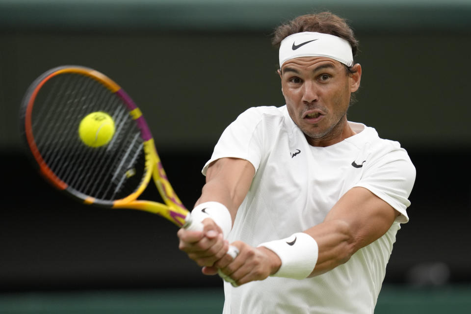 Spain's Rafael Nadal returns to Lithuania's Ricardas Berankis in a second round men's singles match on day four of the Wimbledon tennis championships in London, Thursday, June 30, 2022. (AP Photo/Kirsty Wigglesworth)