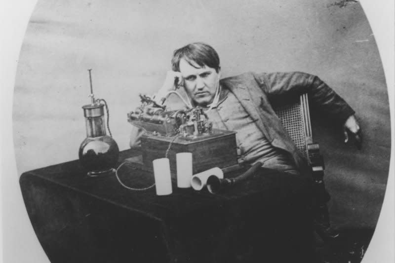 Thomas Edison poses in his laboratory in Orange, N.J., on June 16, 1888, amidst his first gramophone invention. On August 11, 1877, Thomas Edison described the fundamentals of the phonograph to an assistant and instructed him to build the first one. UPI File Photo