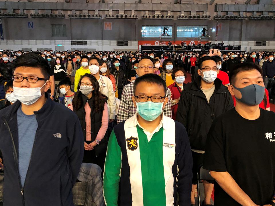 FILE PHOTO: Foxconn employees wearing masks attend the company's year-end gala in Taipei, Taiwan January 22, 2020. REUTERS/Yimou Lee/File Photo