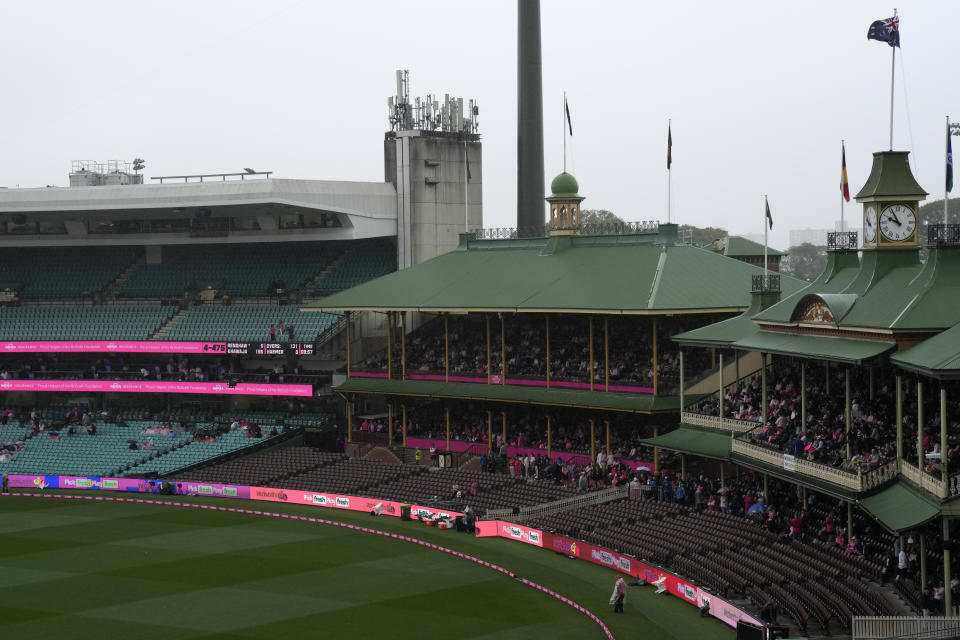 The stands are sparsely attended as rain falls before play on the third day of the cricket test match between Australia and South Africa at the Sydney Cricket Ground in Sydney, Friday, Jan. 6, 2023. (AP Photo/Rick Rycroft)