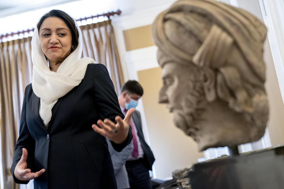 Afghan Ambassador to the U.S. Roya Rahmani, accompanied by embassy staff, speaks as she gives the Associated Press a tour at the Afghanistan Embassy in Washington, Wednesday, April 21, 2021, of looted and stolen Afghan religious relics and antiquities recovered by U.S. government authorities as part of a wider investigation into global trafficking in rare and ancient artifacts. (AP Photo/Andrew Harnik)