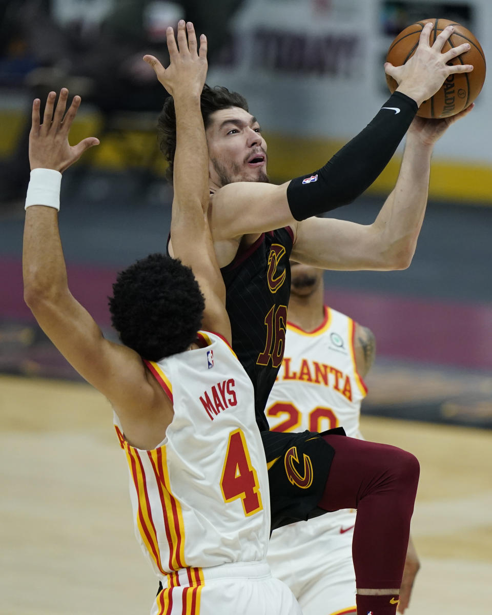 Cleveland Cavaliers' Cedi Osman (16) drives to the basket against Atlanta Hawks' Skylar Mays (4) in the first half of an NBA basketball game, Tuesday, Feb. 23, 2021, in Cleveland. (AP Photo/Tony Dejak)