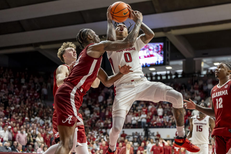 Arkansas guard Khalif Battle (0) works inside against Alabama forward Nick Pringle (23) during overtime in an NCAA college basketball game, Saturday, March 9, 2024, in Tuscaloosa, Ala. (AP Photo/Vasha Hunt)