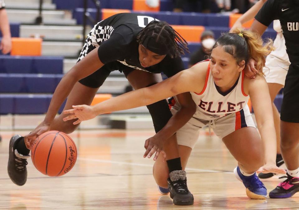 Buchtel's Cassidy Blackmon and Ellet's Trey Moore battle for the ball in the first half of Ellet's 63-24 City Series win Monday night. [Mike Cardew/Beacon Journal]