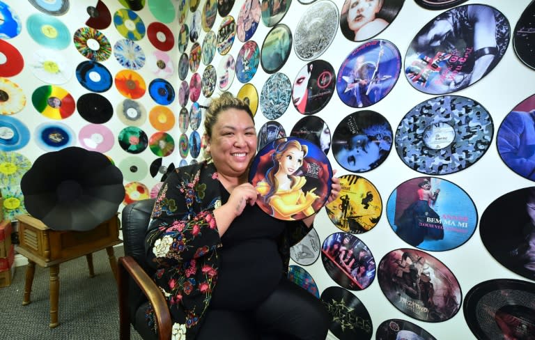 Ma Nerriza dela Cerna of Erika Records displays a full color "Beauty and the Beast" record at the company's office in Buena Park, California on April 12, 2017, where the record manufacturing business has been pressing vinyl for over 30 years