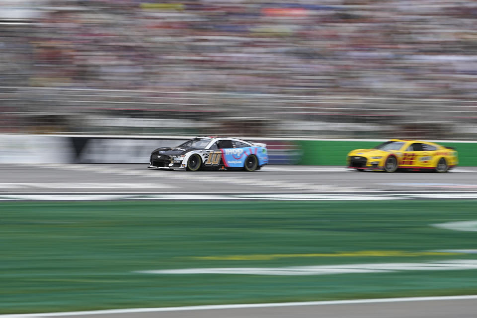 Drivers Aric Almirola (10) and Joey Logano (22) lead during a NASCAR Cup Series auto race at Atlanta Motor Speedway on Sunday, July 9, 2023, in Hampton, Ga. (AP Photo/Brynn Anderson)