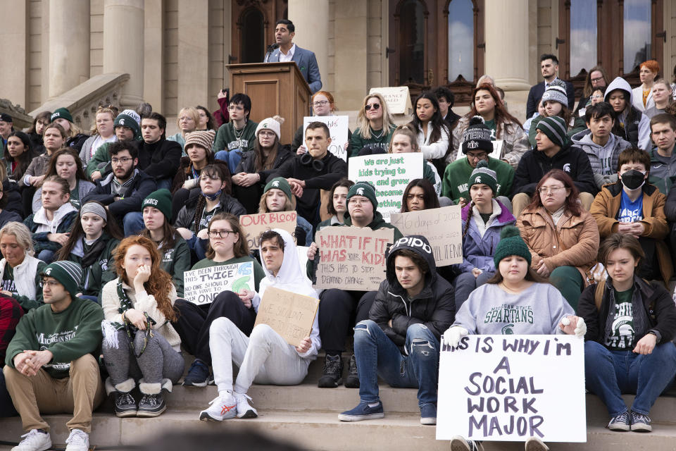 FILE - Protesters hold signs to protest gun violence at a student sit in at the Michigan state Capitol in Lansing, Mich., Feb. 15, 2023, following a mass shooting at Michigan State University earlier in the week. Michigan Democrats are poised to bring an 11-bill package to the Legislature next week that would implement safe storage laws, universal background checks and extreme risk protection orders, also known as red flag laws. A February mass shooting at MSU pushed Democrats to act fast on legislation they had already planned to prioritize. (Brice Tucker/The Flint Journal via AP, File)