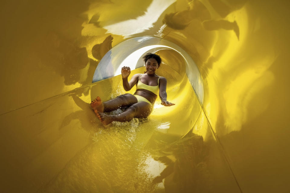 Aubrey Lovelace,12, heads down one of two new slides at the Southside Family Aquatics Facility, Monday, June 28, 2021. After being closed for nearly two-years, the Spokane County run aquatics park is back open to the public just in time to take the edge off the heat wave. Besides the new slides, more shade umbrellas have been added and the concessions are now run by the Spokane Indians baseball organization. (Colin Mulvany/The Spokesman-Review via AP)