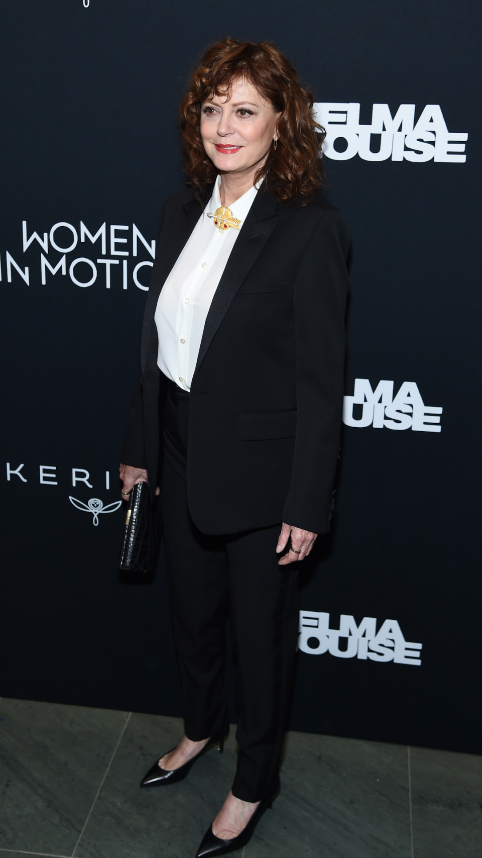 <p> Sarandon was the epitome of elegance at a screening of Thelma & Louise in New York in 2020. The actress wore a chic black trouser suit, paired with a buttoned-up white blouse. She finished off the tailored look with a red lip, chunky gold necklace, black clutch bag and black kitten heels. </p>