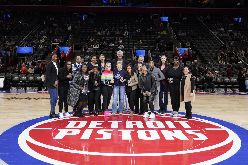 The 2003 Detroit Shock women's basketball team poses at mid-court after being honored during halftime of an NBA basketball game between the Detroit Pistons and the Charlotte Hornets, Thursday, March 9, 2023, in Detroit. (AP Photo/Carlos Osorio)