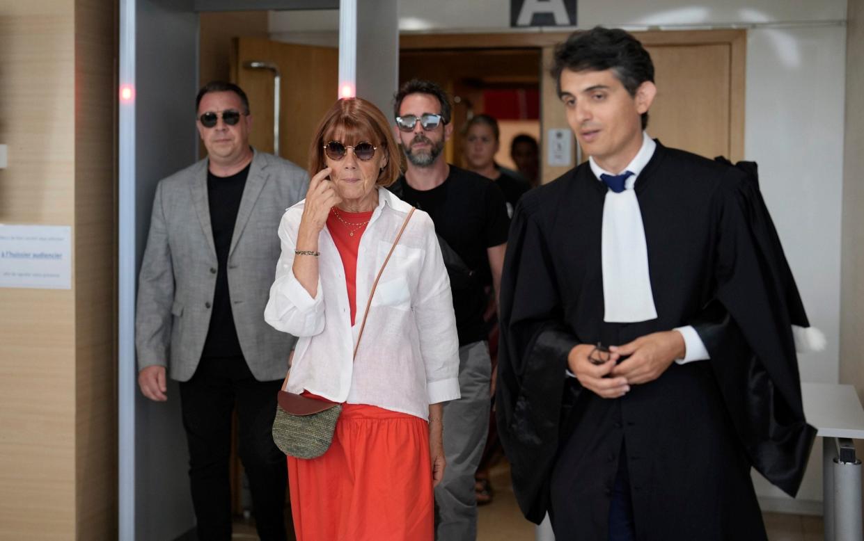 Gisèle Pélicot, centre left, leaves the Avignon court house with her sons, David, left, Florian, center background and her lawyer Stephane Babonneau, right, in Avignon, southern France