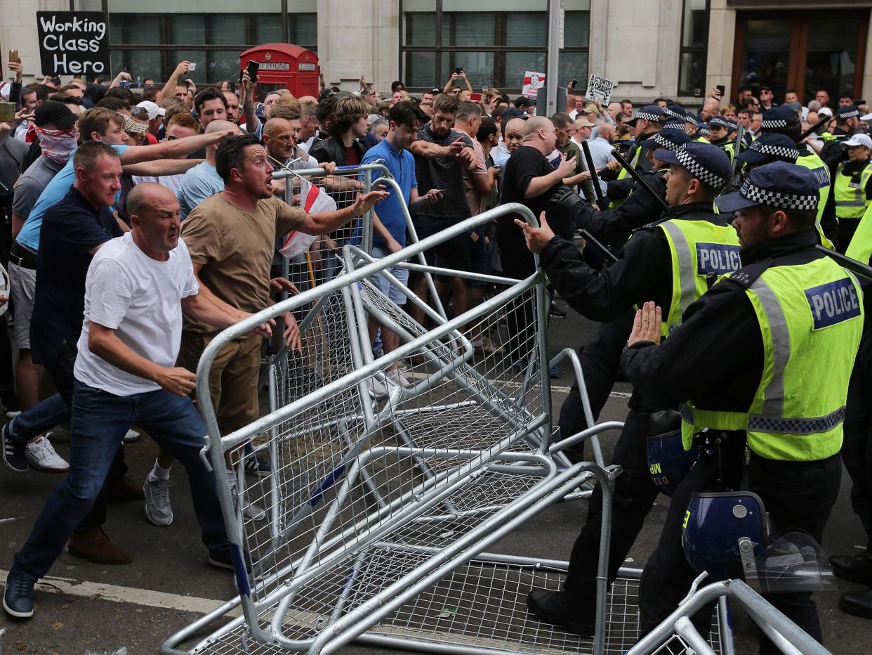 Protesters scuffle with police at the junction of Whitehall and The Mall during a 'Free Tommy Robinson' protest on 9 June: AFP/Getty Images