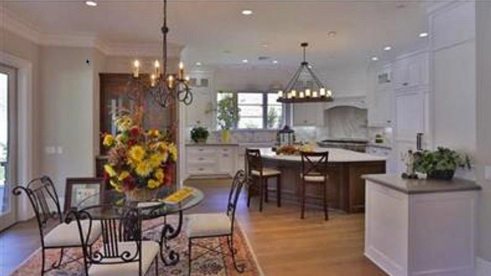 <p>The home has an elegant kitchen, with a massive centre island, wood floors and access to the backyard. (Trulia.com) </p>