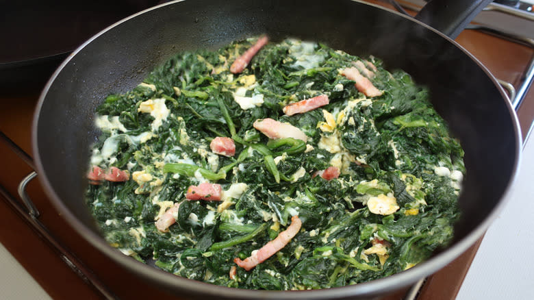 lardons, greens in frying pan