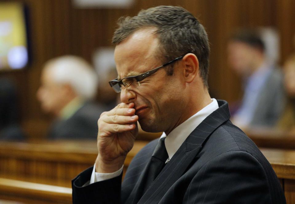 Olympic and Paralympic track star Oscar Pistorius sits in the dock at the North Gauteng High Court in Pretoria March 11, 2014. Pistorius is on trial for the murder of his girlfriend Reeva Steenkamp at his suburban Pretoria home on Valentine's Day last year. REUTERS/Kim Ludbrook/Pool (SOUTH AFRICA - Tags: SPORT CRIME LAW)