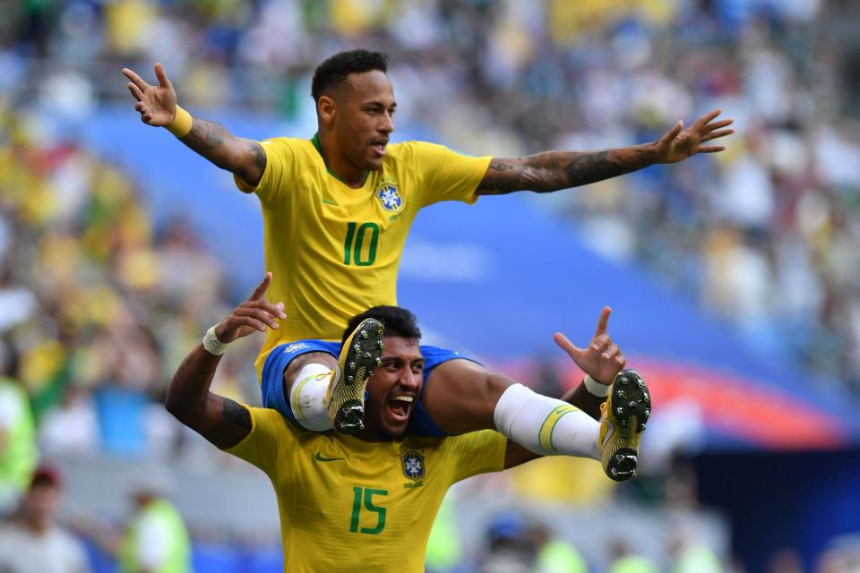 Brazil’s forward Neymar celebrates with Brazil’s midfielder Paulinho after scoring the opening goal during the Russia 2018 World Cup round of 16 football match between Brazil and Mexico at the Samara Arena in Samara on July 2, 2018. (Getty Images)