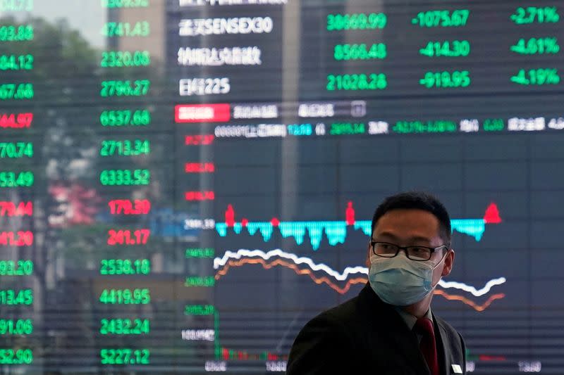 A man wearing a protective mask is seen inside the Shanghai Stock Exchange building, as the country is hit by a new coronavirus outbreak, at the Pudong financial district in Shanghai