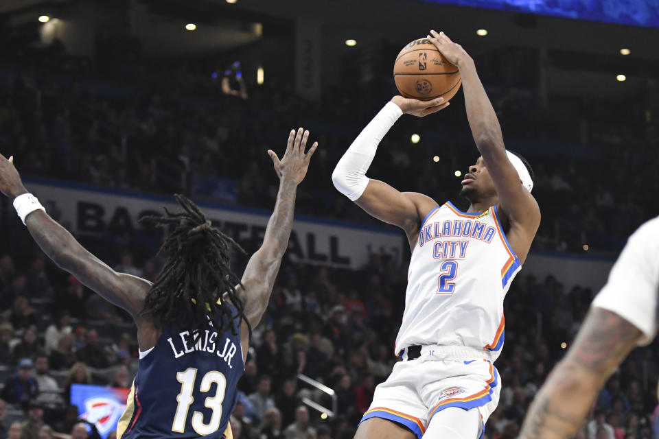 Oklahoma City Thunder guard Shai Gilgeous-Alexander (2) shoots the ball over New Orleans Pelicans guard Kira Lewis Jr, (13) in the first half of an NBA basketball game, Wednesday, Nov. 1, 2023, in Oklahoma City. (AP Photo/Kyle Phillips)
