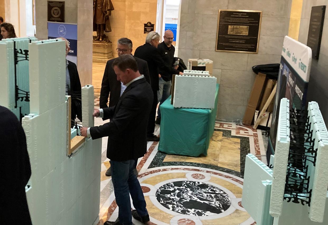 Concrete industry representatives set up construction models using concrete and polystyrene in construction in the Nurses Hall of the Massachusetts Statehouse Wednesday to demonstrate the benefits of its use in building everything from single-family homes to sidewalks and highways.