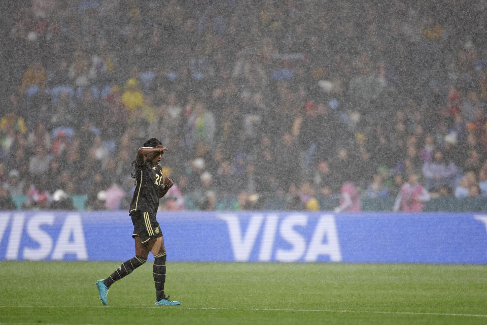 Jamaica's Cheyna Matthews shields her eyes as rain intensifies during the Women's World Cup Group F soccer match between France and Jamaica at Sydney Football Stadium in Sydney, Australia, Sunday, July 23, 2023. (AP Photo/Sophie Ralph)