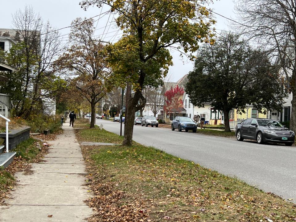 Burlington Police can be seen on the left sidewalk and right sidewalk canvassing an Old North End street on Nov. 13, 2023, the day after a double homicide in the neighborhood.