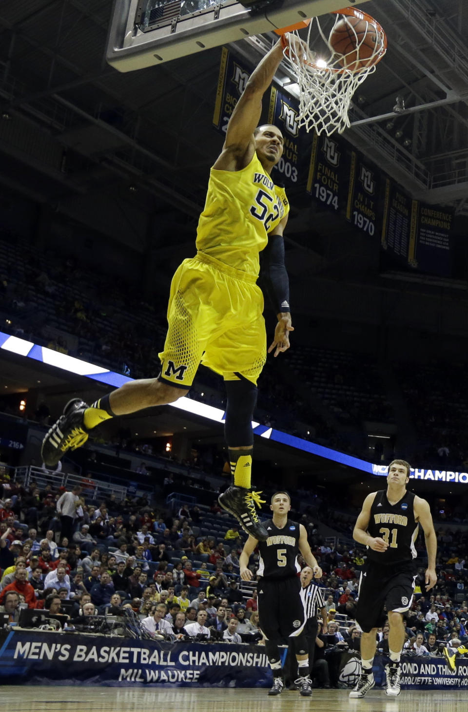 Michigan forward Jordan Morgan (52) dunks during the first half of a second round NCAA college basketball tournament game against the Wofford Thursday, March 20, 2014, in Milwaukee. (AP Photo/Morry Gash)