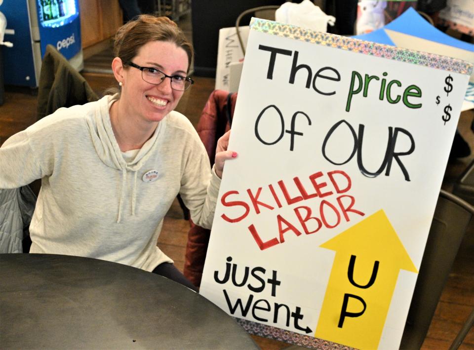 Nurse Lisa Cutler holds up her picket sign at a Sunday work party in preparation for a possible ProMedica nurses strike.