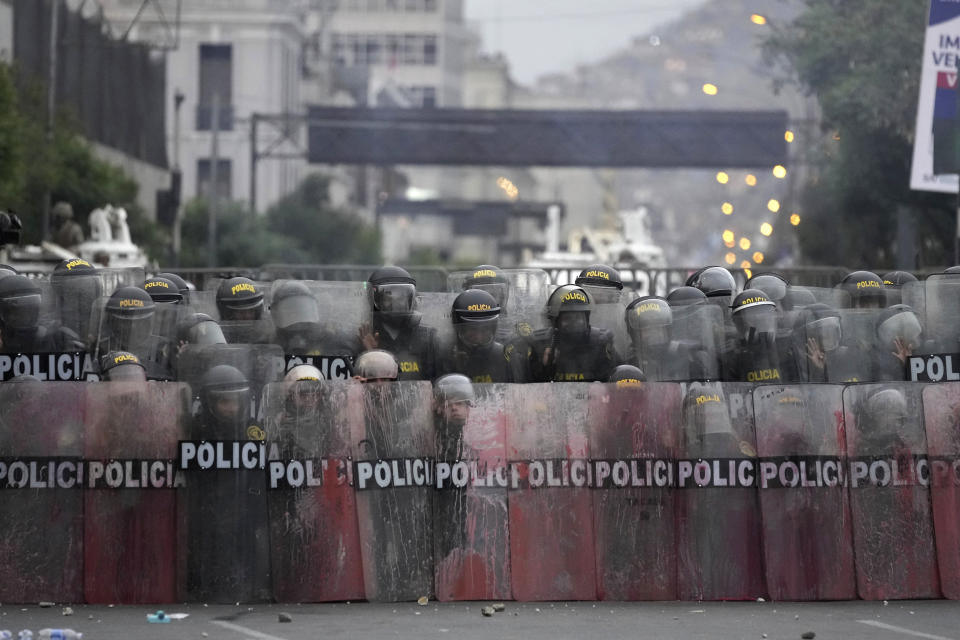 A phalanx of police face off with anti-government protesters seeking immediate elections, President Dina Boluarte's resignation, the release of ousted President Pedro Castillo and justice for protesters killed in clashes with police. in Lima, Peru, Saturday, Jan. 28, 2023. (AP Photo/Martin Mejia)