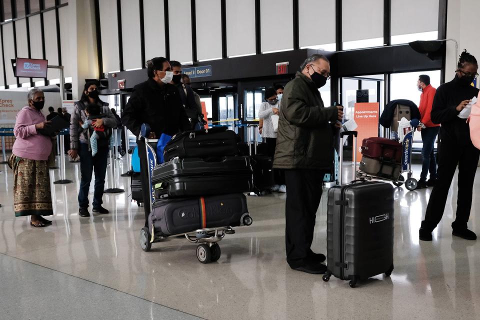 Travelers arrive for flights at Newark Liberty International Airport on November 30, 2021 in Newark, New Jersey.