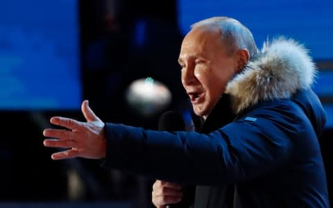 Vladimir Putin speaks to supporters outside the Kremlin on Sunday evening - Credit: Grigory Dukor/Reuters