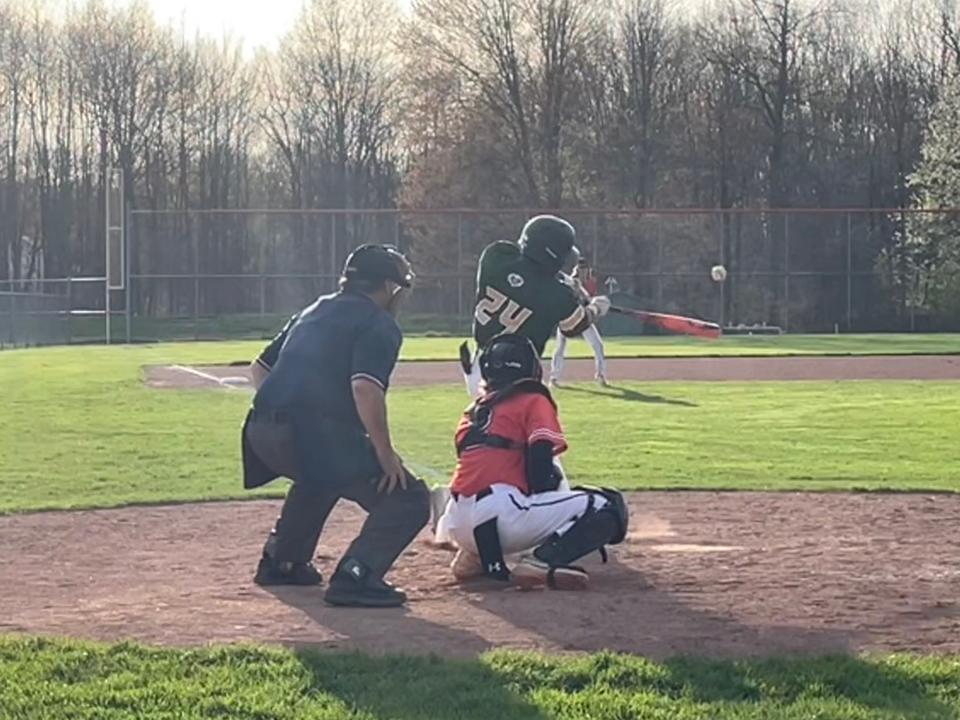 GlenOak's Quincy Mazeke blasts a double during the sixth inning of the Golden Eagles' 13-2 high school baseball win at Green on Tuesday, April 16, 2024.