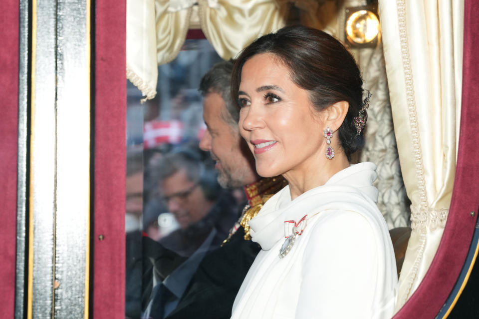 Denmark's King Frederik X and Queen Mary ride in a coach back to Amalienborg Palace after the proclamation, in Copenhagen, Sunday, Jan. 14, 2024. Denmark’s prime minister proclaimed Frederik X as king after his mother Queen Margrethe II formally signed her abdication. Massive crowds turned out to rejoice in the throne passing from a beloved monarch to her popular son. (Emil Nicolai Helms/Ritzau Scanpix via AP)