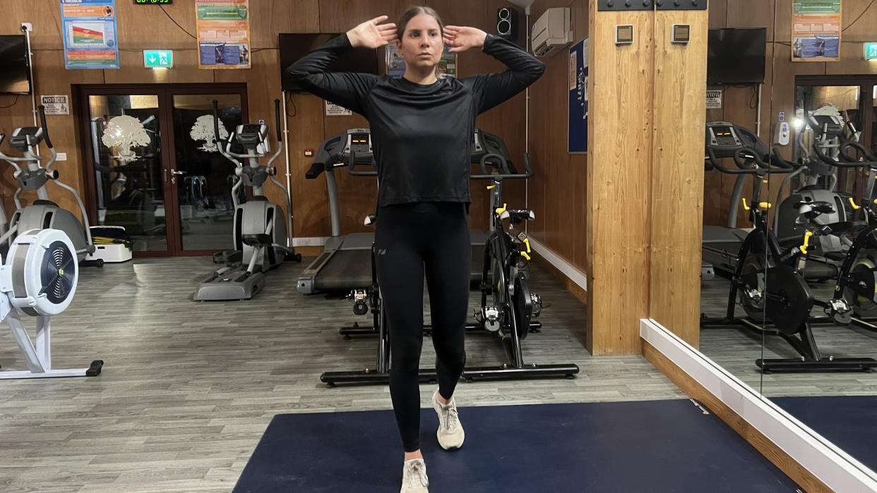  Fitness writer Daniella Gray doing a walking workout in a gym setting. 