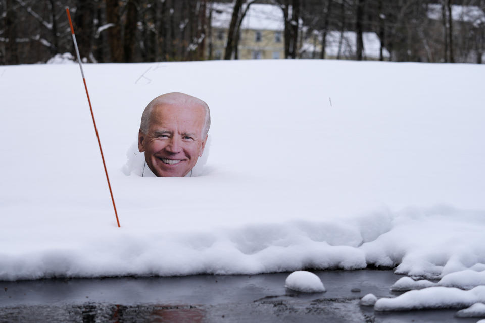 A cutout of President Biden is surrounded by snow next to the driveway of a home, Friday, April 5, 2024, in Derry, N.H. Many New Englanders are cleaning up following a major spring storm on Thursday that brought heavy snow, rain and high winds to the Northeast. Hundreds of thousands of homes and businesses are still without power in Maine and New Hampshire. (AP Photo/Charles Krupa)