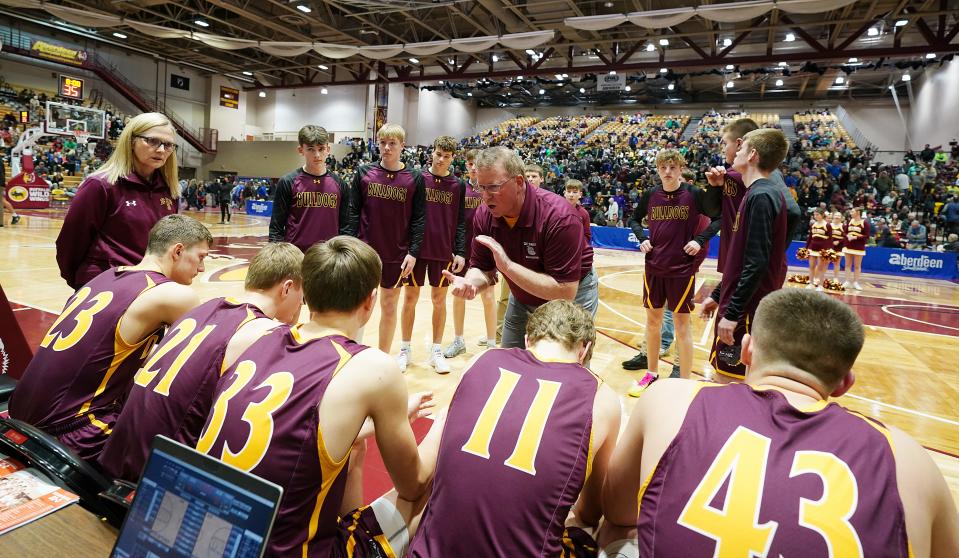 De Smet head boys basketball coach Jeff Gruenhagen talks to his players during a timeout in the 2023 state Class B tournament last weekend in Aberdeen. The Bulldogs won their third-straight state B championship.