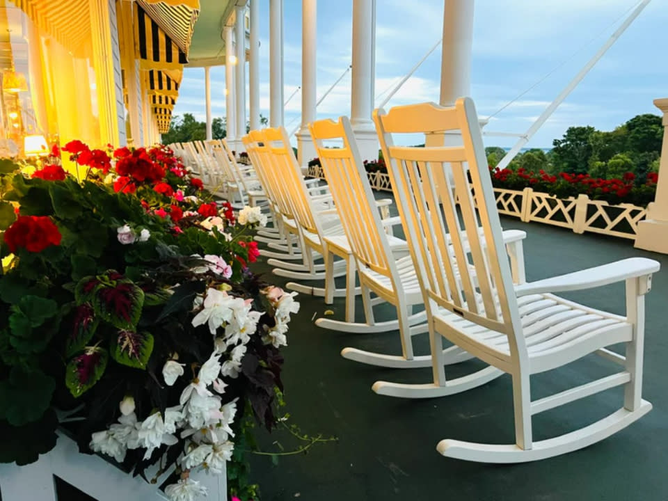 Several white rocking chairs line the porch of the Grand Hotel. (Courtesy Grand Hotel)
