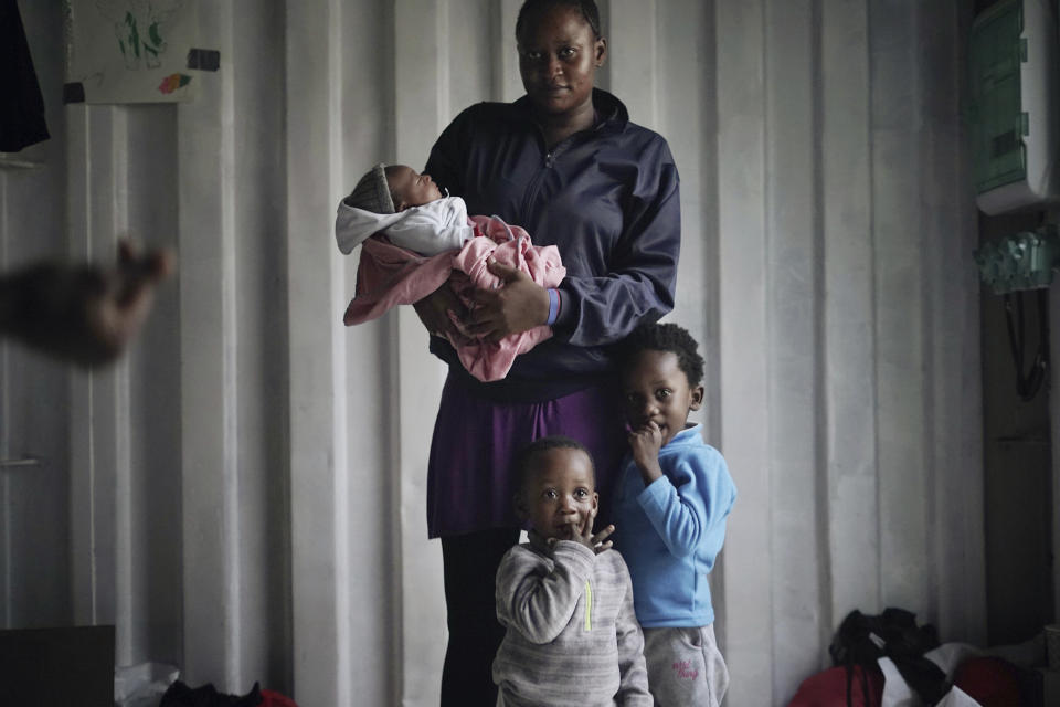 In this Sept. 23, 2019 photo, Prudence Aimee, 30, from Cameroon poses for a photo with her children, from left Ange, Wifrid, 1, and William, 3, aboard the humanitarian rescue ship Ocean Viking in Italian waters off the Sicilian town of Messina, southern Italy, hours before disembarking. Aimee left Cameroon in 2015, and when her family heard nothing from her for two years, they thought she was dead. But she was in detention and incommunicado. In nine months at Libya's Abu Salim detention center, she saw “European Union milk” and diapers delivered by UN staff pilfered before they could reach migrant children, including her toddler son. Aimee herself would spend two days at a time without food or drink. (AP Photo/Renata Brito)