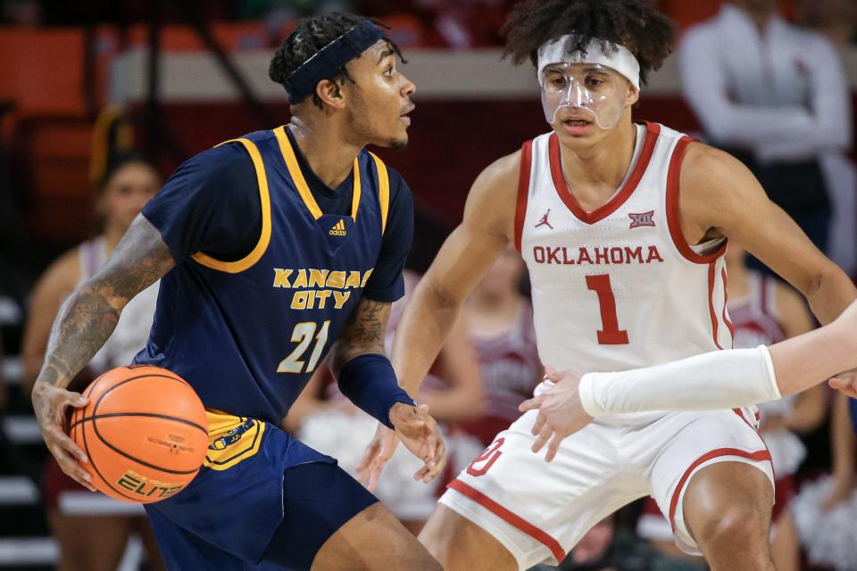 Kansas City guard RayQuawndis Mitchell (21) looks to pass as Oklahoma forward Jalen Hill (1) guards in the second half during a college basketball game between the Oklahoma Sooners (OU) and the Kansas City Kangaroos at Lloyd Noble Center in Norman, Okla., Tuesday, Dec. 6, 2022.