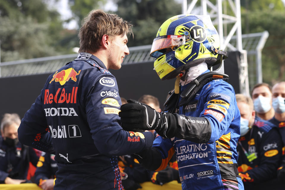 First placed Red Bull's Max Verstappen, left, greets third placed McLaren's Lando Norris at the end of the Emilia Romagna Formula One Grand Prix, at the Imola racetrack, Italy, Sunday, April 18, 2021. (Bryn Lennon/ Pool Via AP)